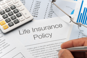 A man is completing a life insurance policy form for his employees