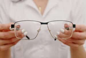 Female employee holding a pair of eyeglasses